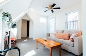 Sitting area with fireplace, ceiling fan and soft lighting