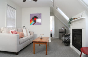 Cozy living room with sofa, coffee table and fireplace