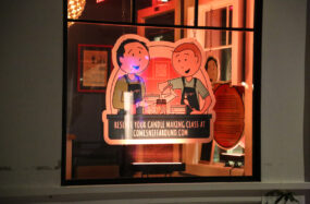 Cartoon style restaurant stickers on a window at night