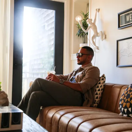Guest relaxing on a leather couch in a stylish lounge