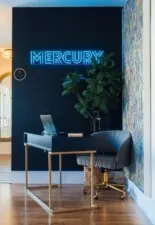 Front desk area with neon Mercury sign and modern decor