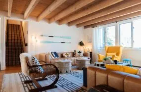 Bright lounge with wood beams, cozy seating and large windows