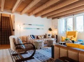 Bright lounge with wood beams, cozy seating and large windows