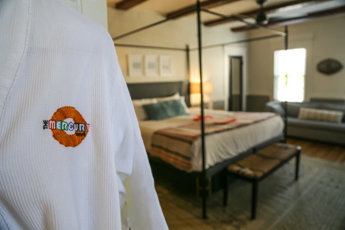 Close up of robe with cozy guest room in background