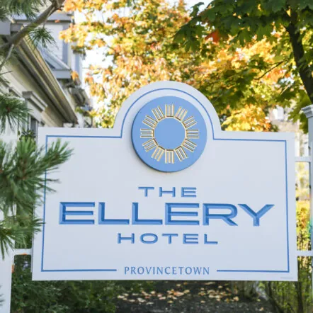 Sign of The Ellery Hotel surrounded by greens